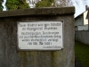 Warning Sign on Cemetery Wall